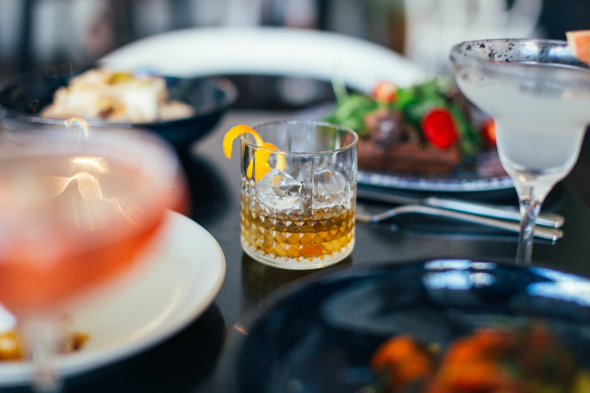 glass of cocktail on a table with other drinks